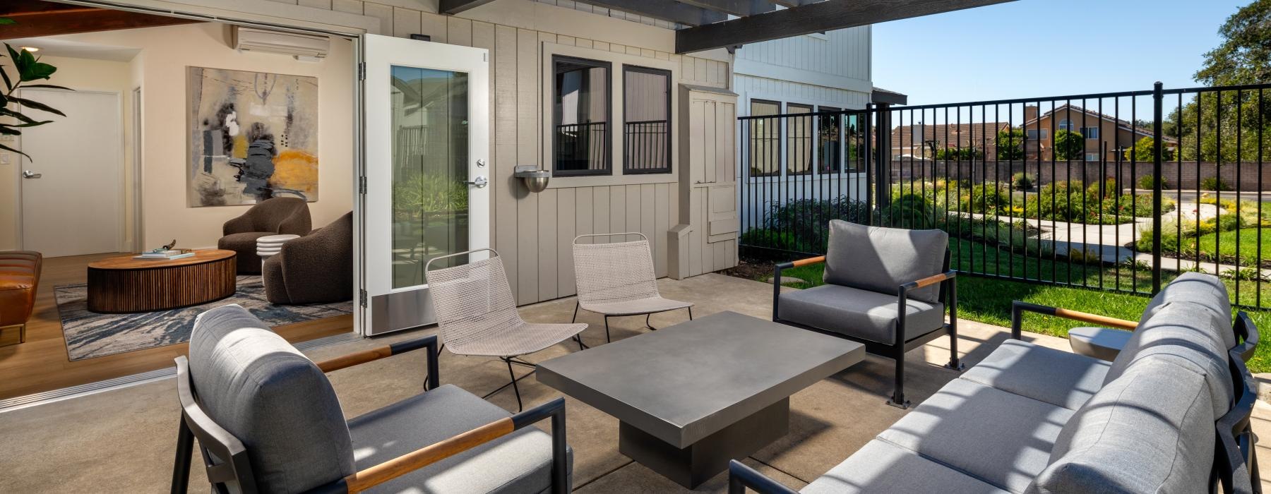 a patio with chairs and a table