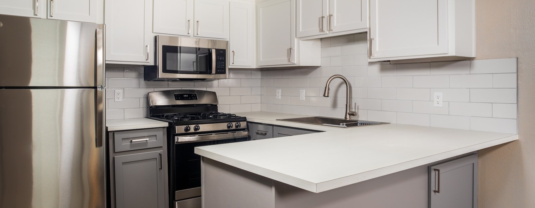 a kitchen with white cabinets