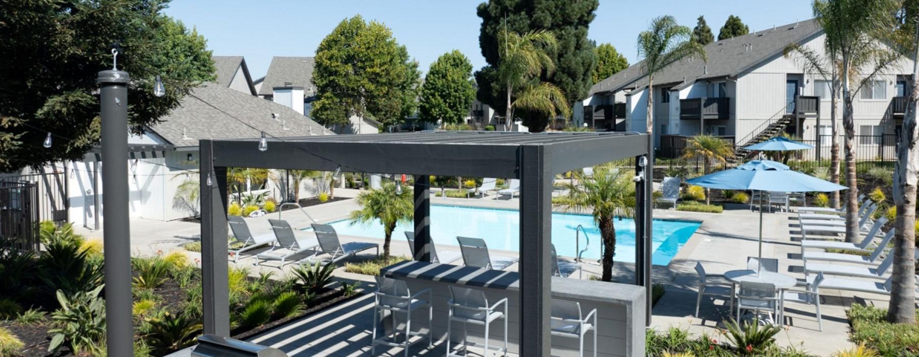 a swimming pool with nearby cabanas