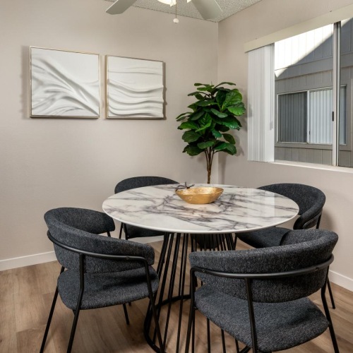 a dining room with a table and chairs